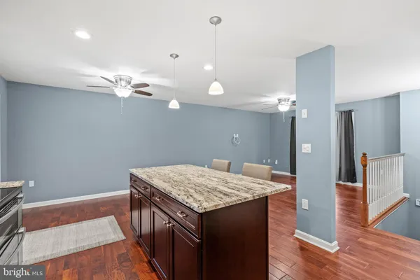 a kitchen that has a lot of cabinets and wooden floor