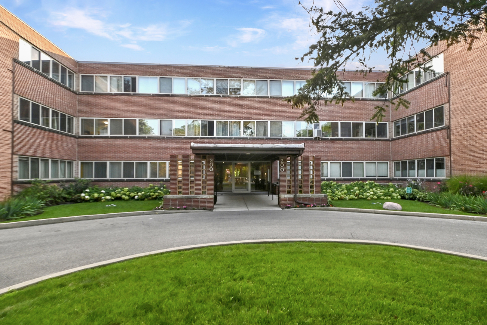 a view of building with a garden
