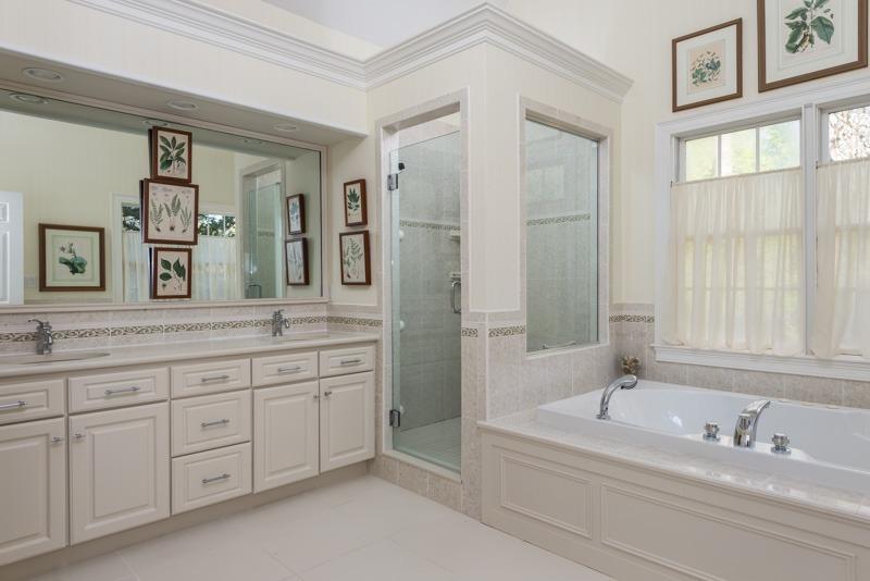 91 Great Bay Road Osterville, MA 02655 - Photo 14 of 27 a spacious bathroom with a granite countertop sink a mirror a bathtub and next to a window
