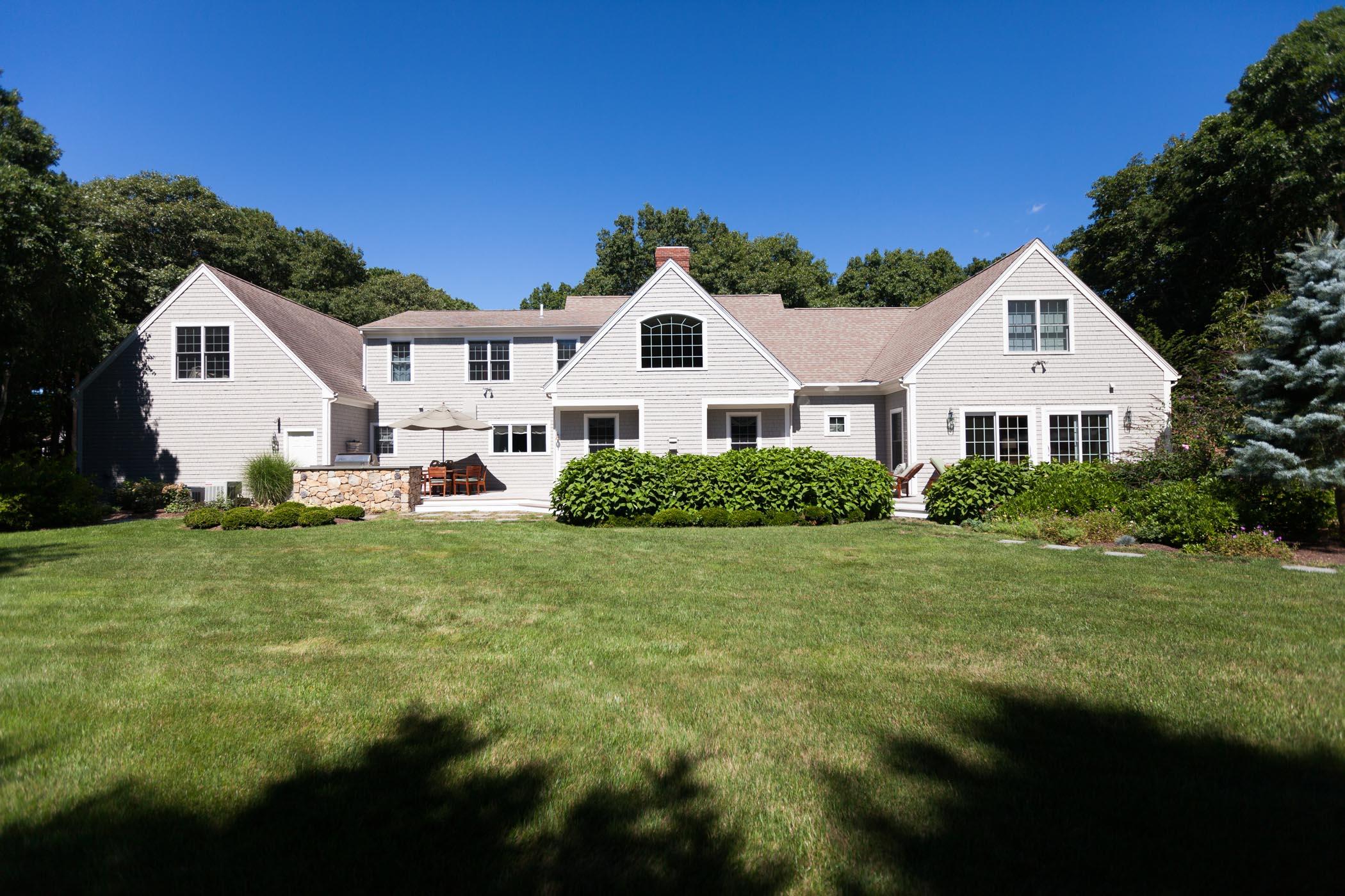 91 Great Bay Road Osterville, MA 02655 - Photo 27 of 27 a view of a yard in front of a house with plants and large tree