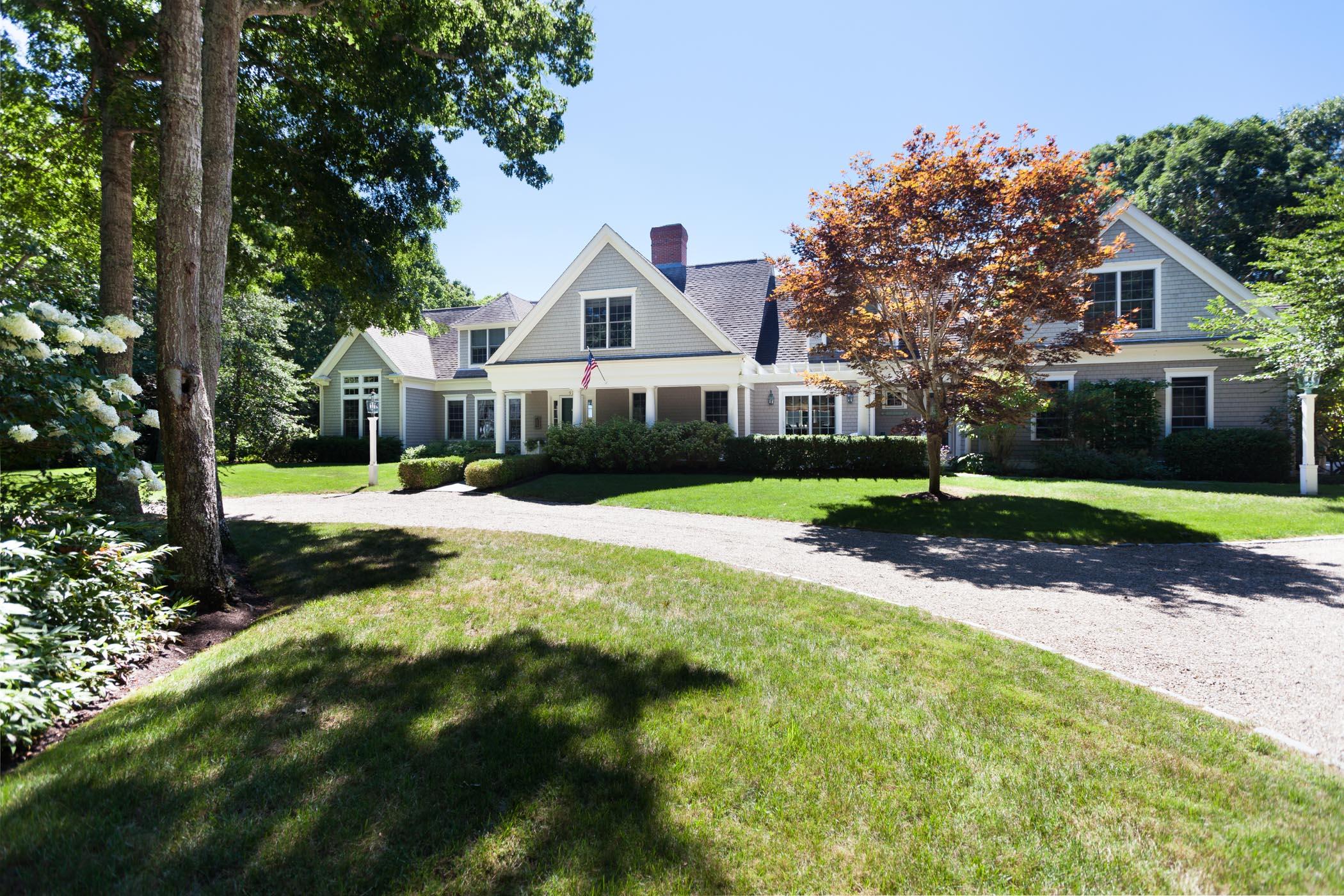 91 Great Bay Road Osterville, MA 02655 - Photo 3 of 27 a front view of a house with a yard and green space