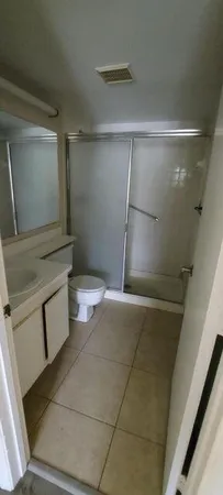 a bathroom with a shower and a toilet