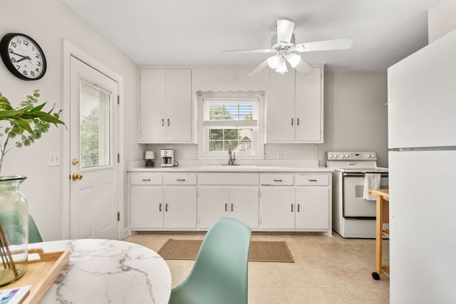 a spacious en suite bathroom with a granite countertop tub and a sink