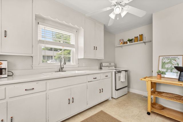 a kitchen with sink cabinets and window
