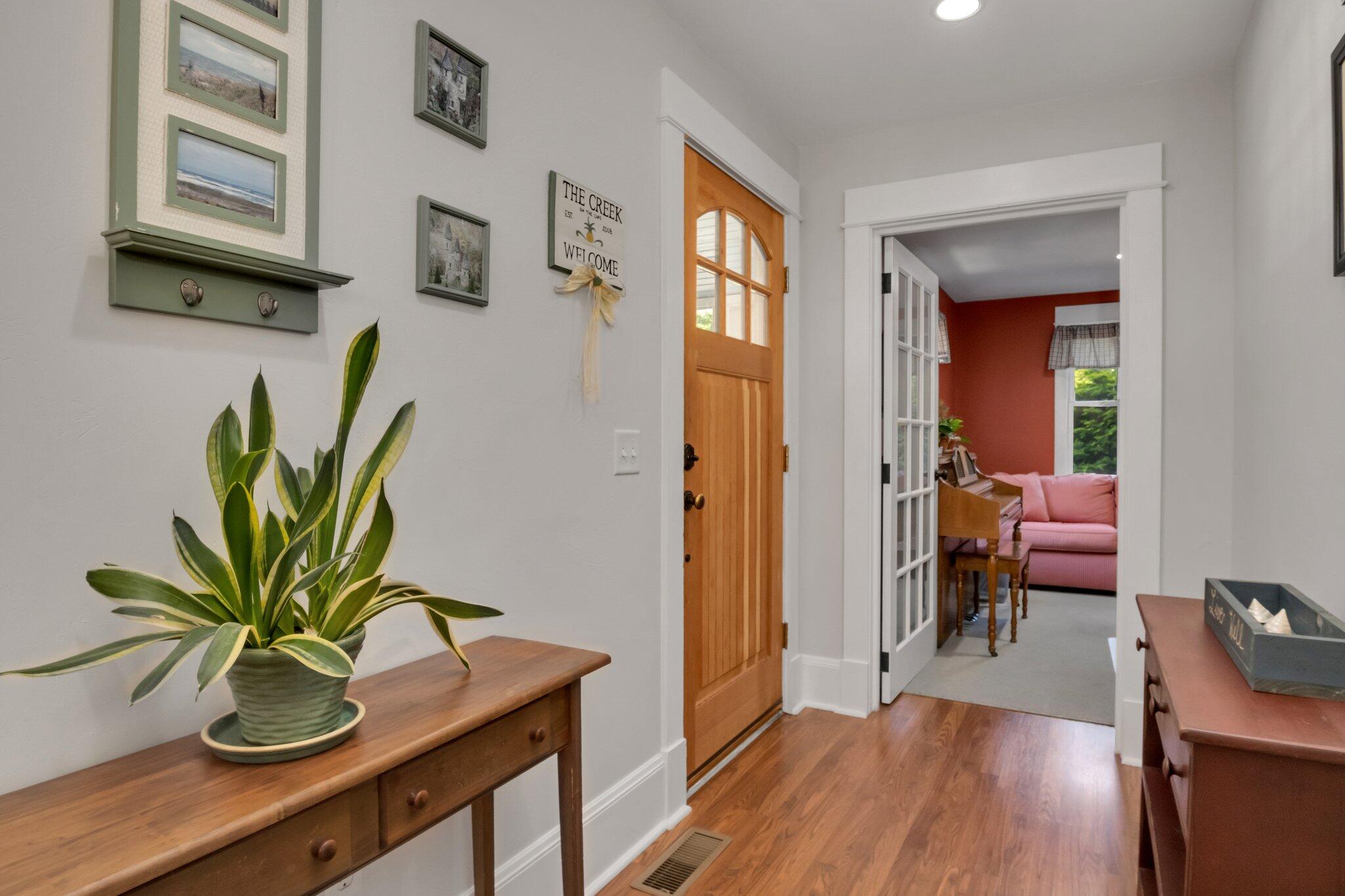 730 Slough Road Brewster, MA 02631 - Photo 11 of 87 a view of a hallway with wooden floor and a potted plant