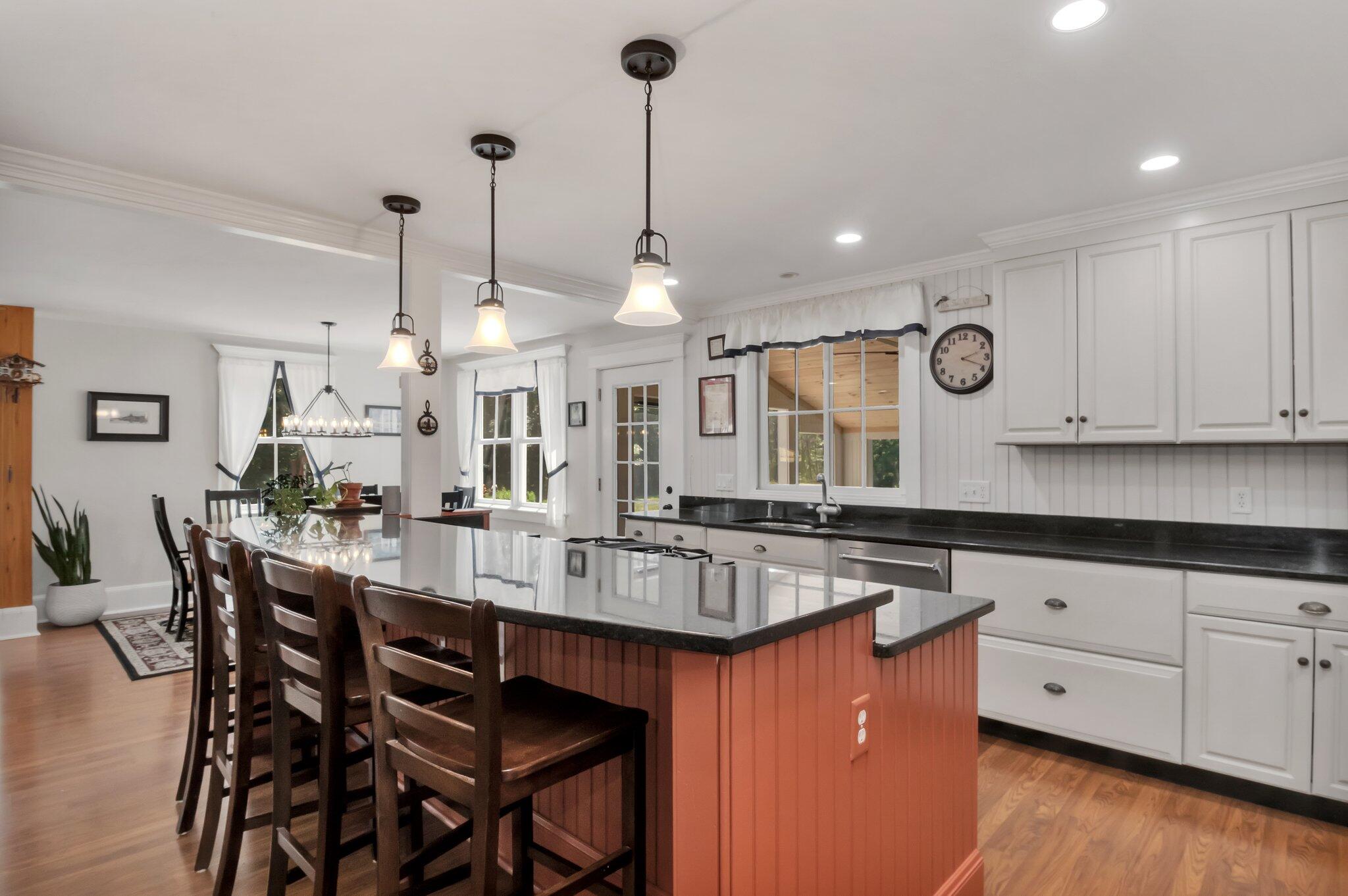 730 Slough Road Brewster, MA 02631 - Photo 16 of 87 a kitchen with stainless steel appliances granite countertop a kitchen island a stove a table and chairs in it