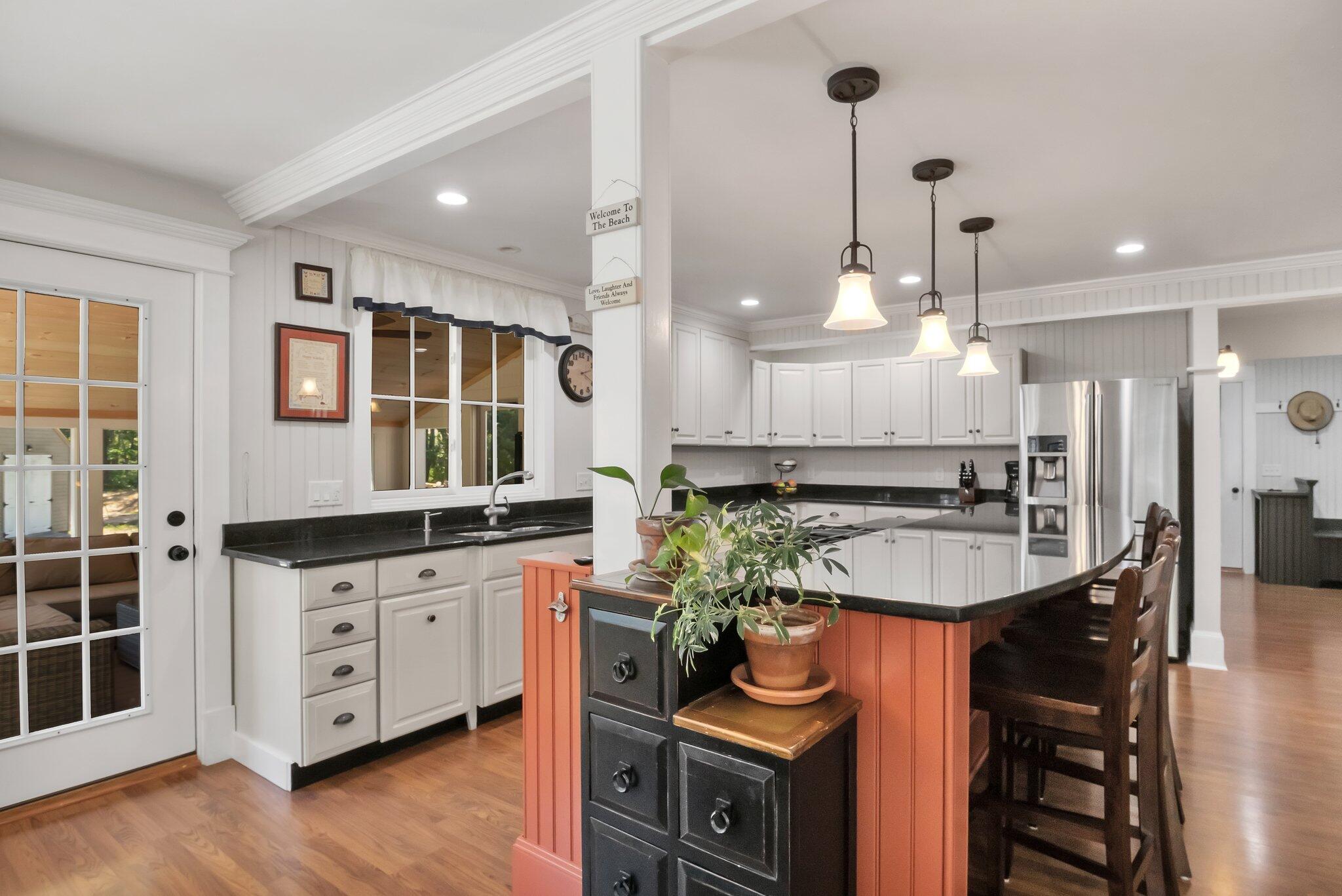 730 Slough Road Brewster, MA 02631 - Photo 18 of 87 a kitchen with stainless steel appliances a sink a stove a chimney a refrigerator and cabinets