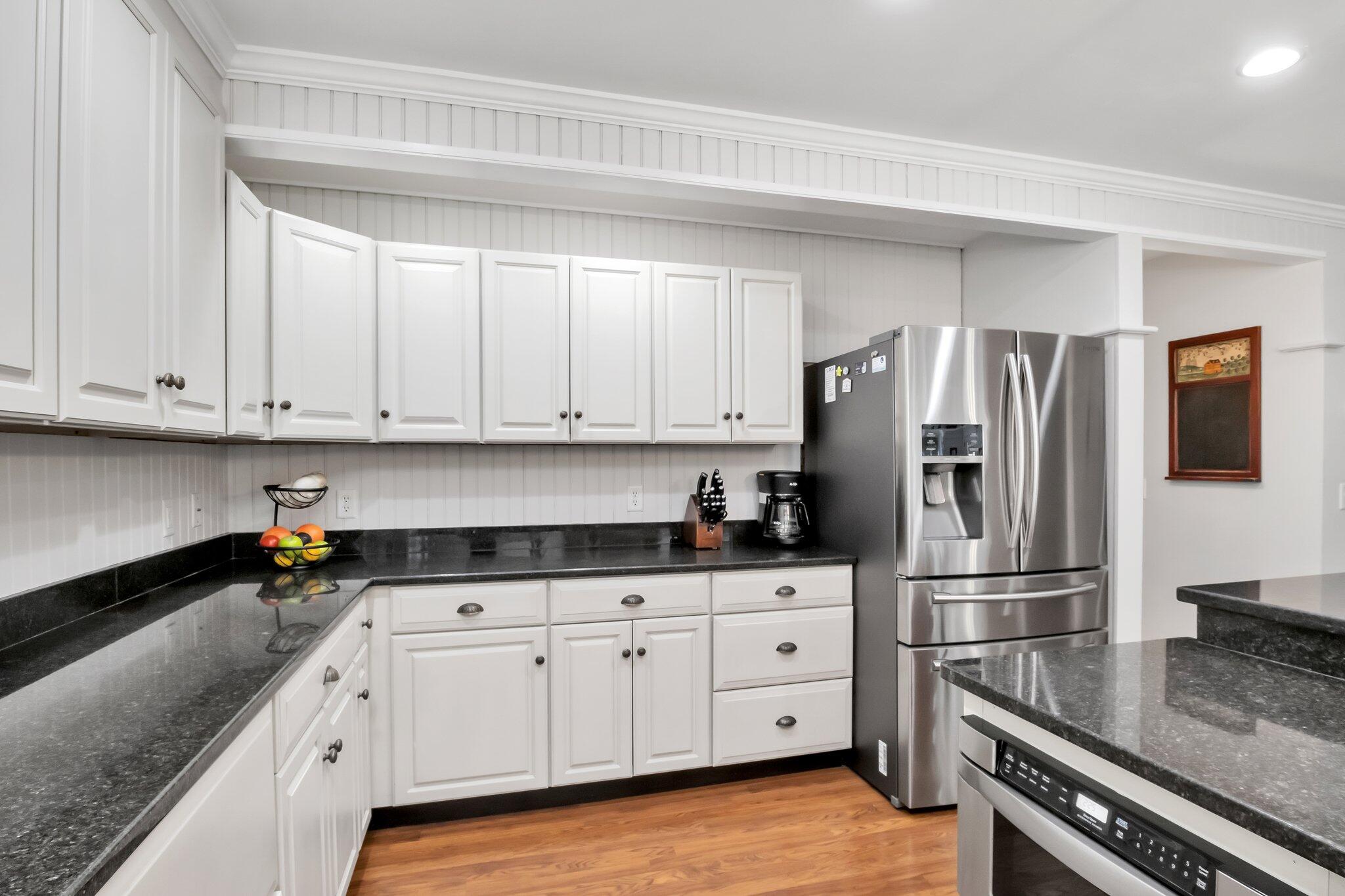 730 Slough Road Brewster, MA 02631 - Photo 22 of 87 a kitchen with granite countertop a refrigerator stove and sink