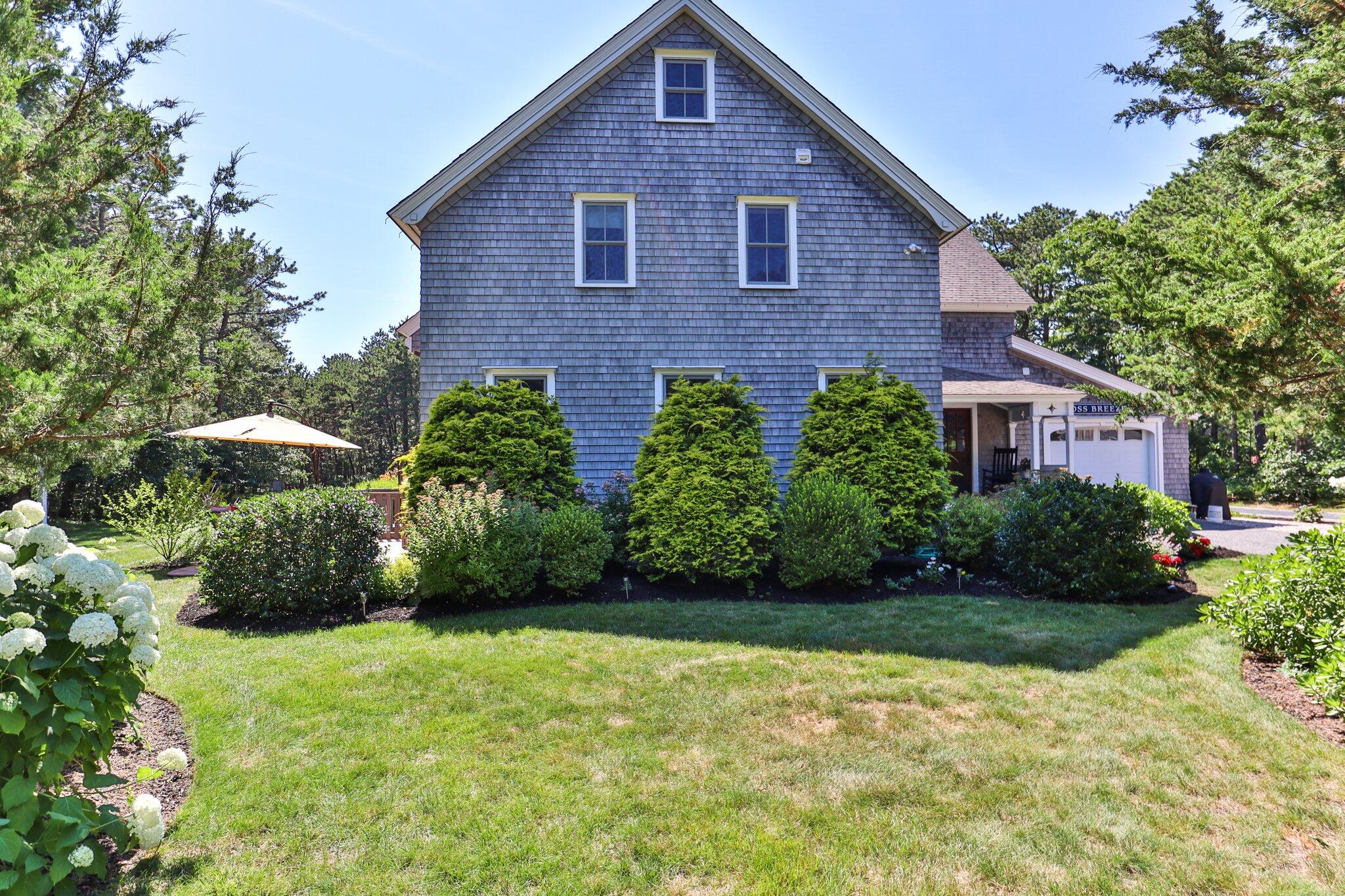 730 Slough Road Brewster, MA 02631 - Photo 3 of 87 a front view of a house with garden
