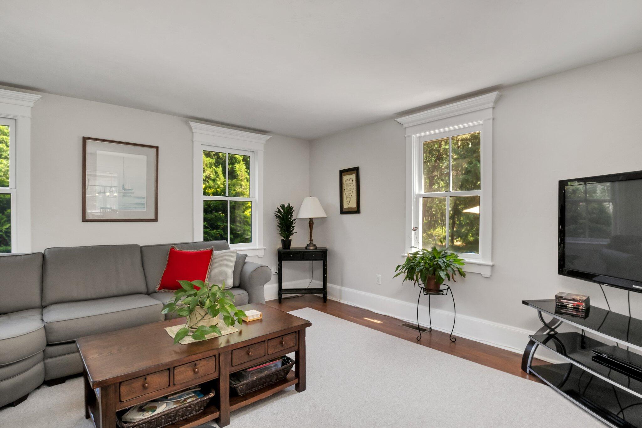 730 Slough Road Brewster, MA 02631 - Photo 31 of 87 a living room with furniture potted plant and a window