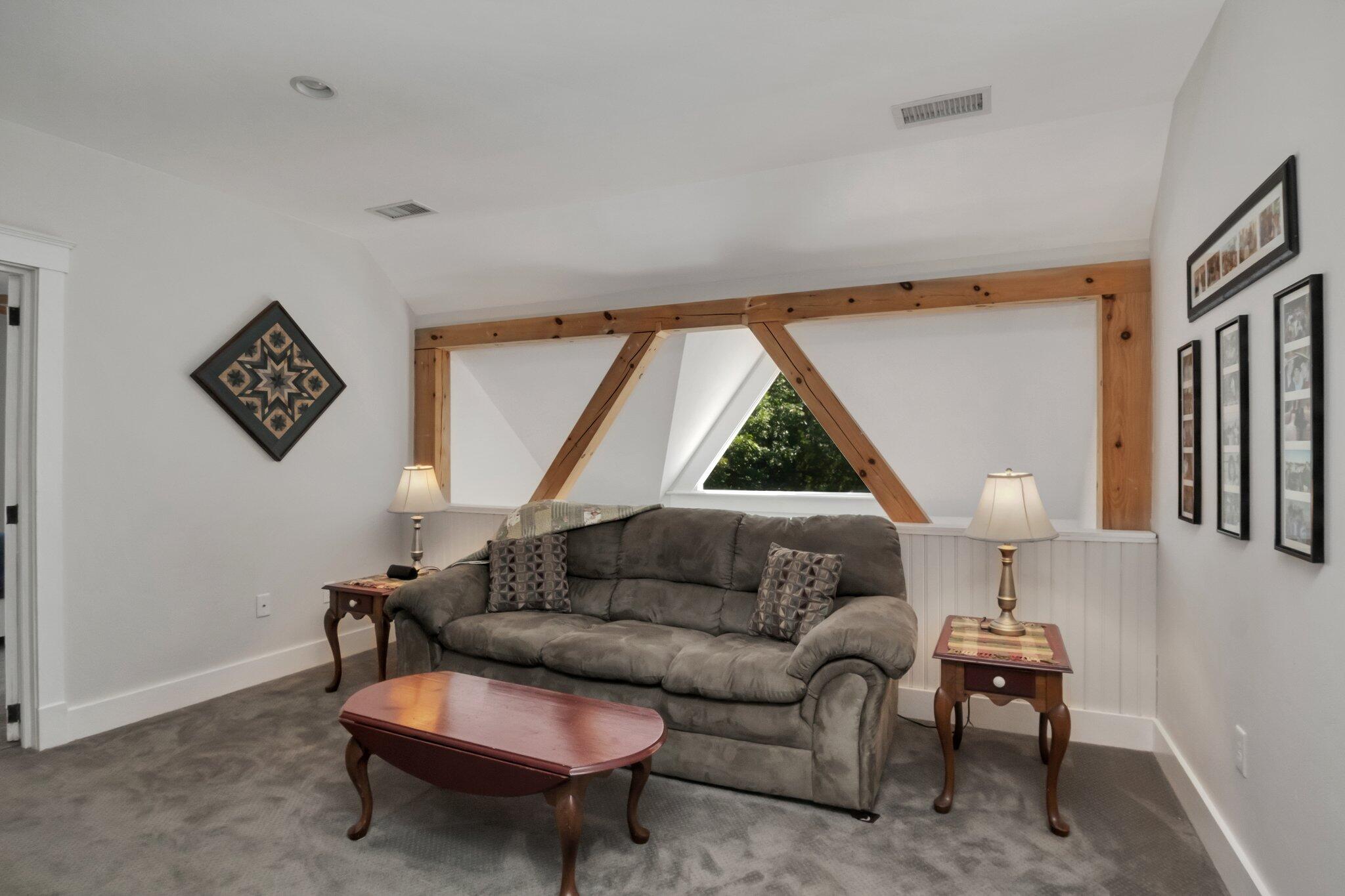 730 Slough Road Brewster, MA 02631 - Photo 38 of 87 a living room with furniture a window and a lamp