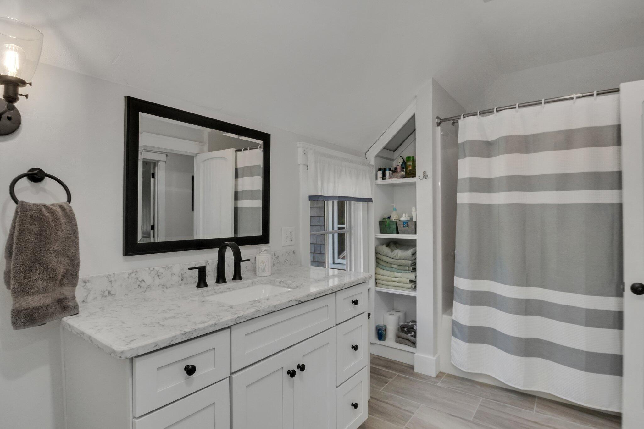 730 Slough Road Brewster, MA 02631 - Photo 46 of 87 a bathroom with a double vanity sink and a mirror