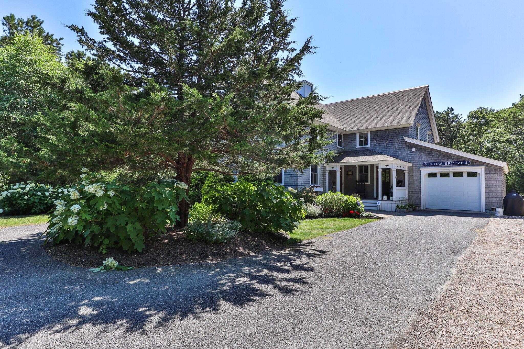 730 Slough Road Brewster, MA 02631 - Photo 5 of 87 a front view of a house with a garden