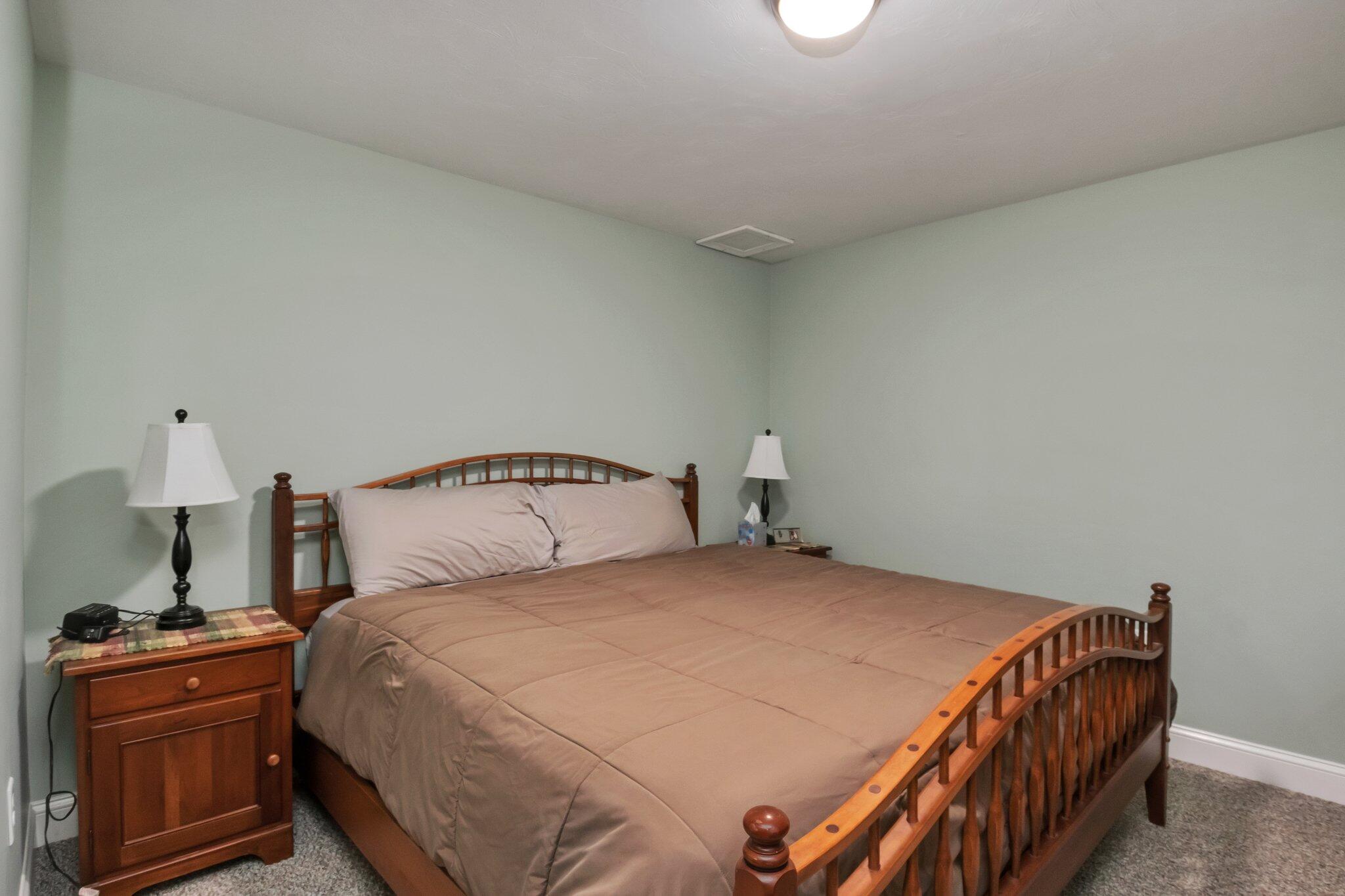 730 Slough Road Brewster, MA 02631 - Photo 59 of 87 a bedroom with a bed and a lamp