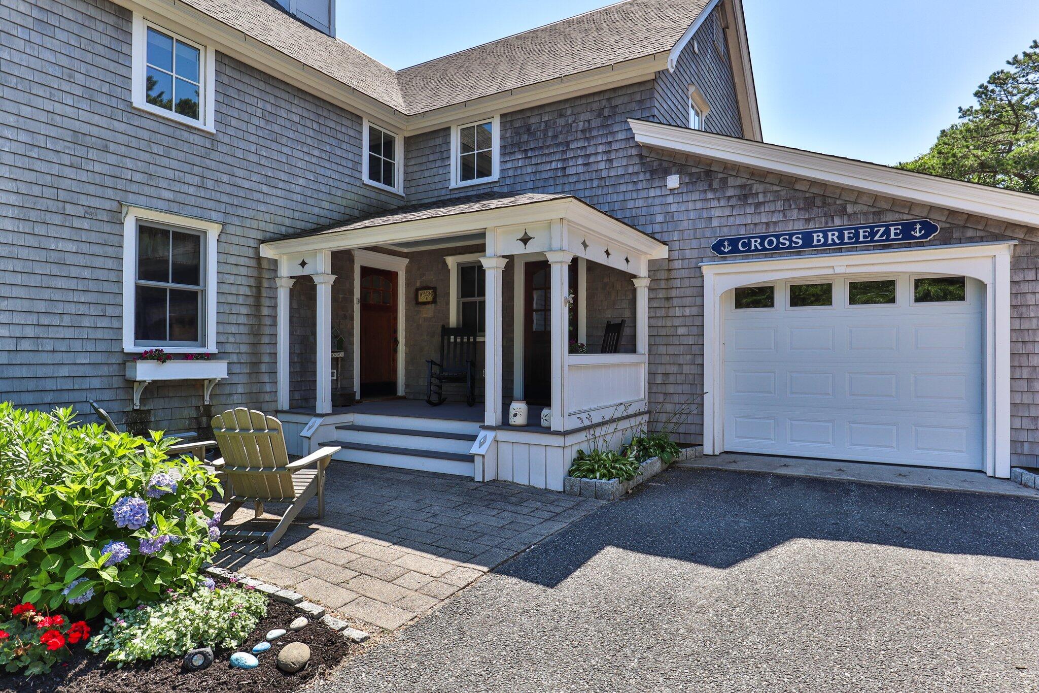 730 Slough Road Brewster, MA 02631 - Photo 6 of 87 a front view of a house with a garden
