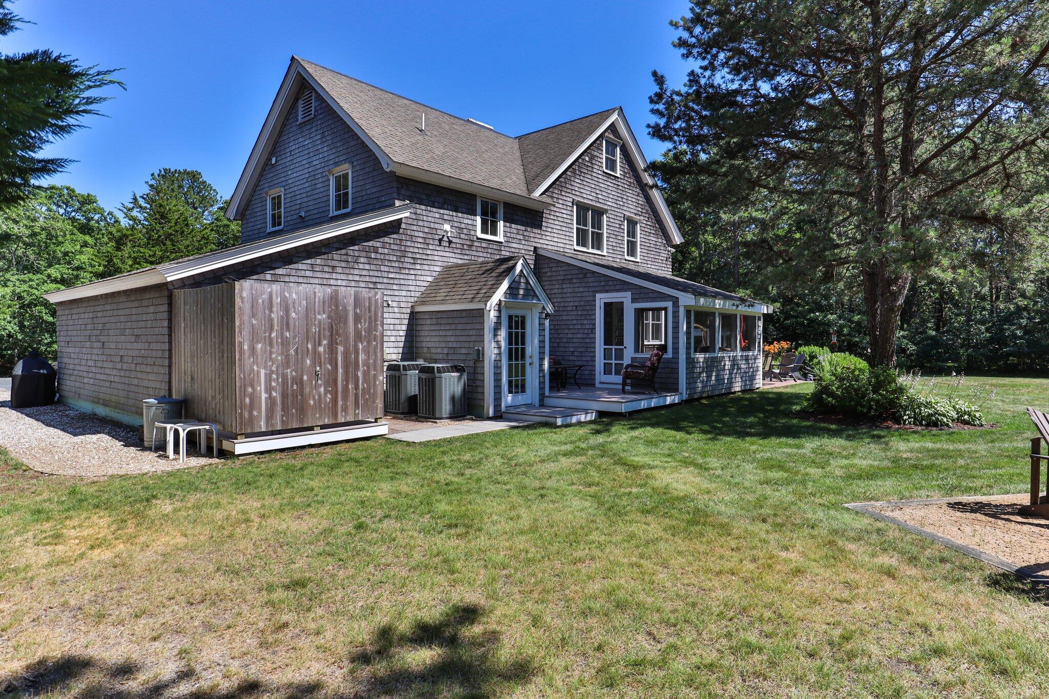 730 Slough Road Brewster, MA 02631 - Photo 63 of 87 a view of a house with a yard and sitting area