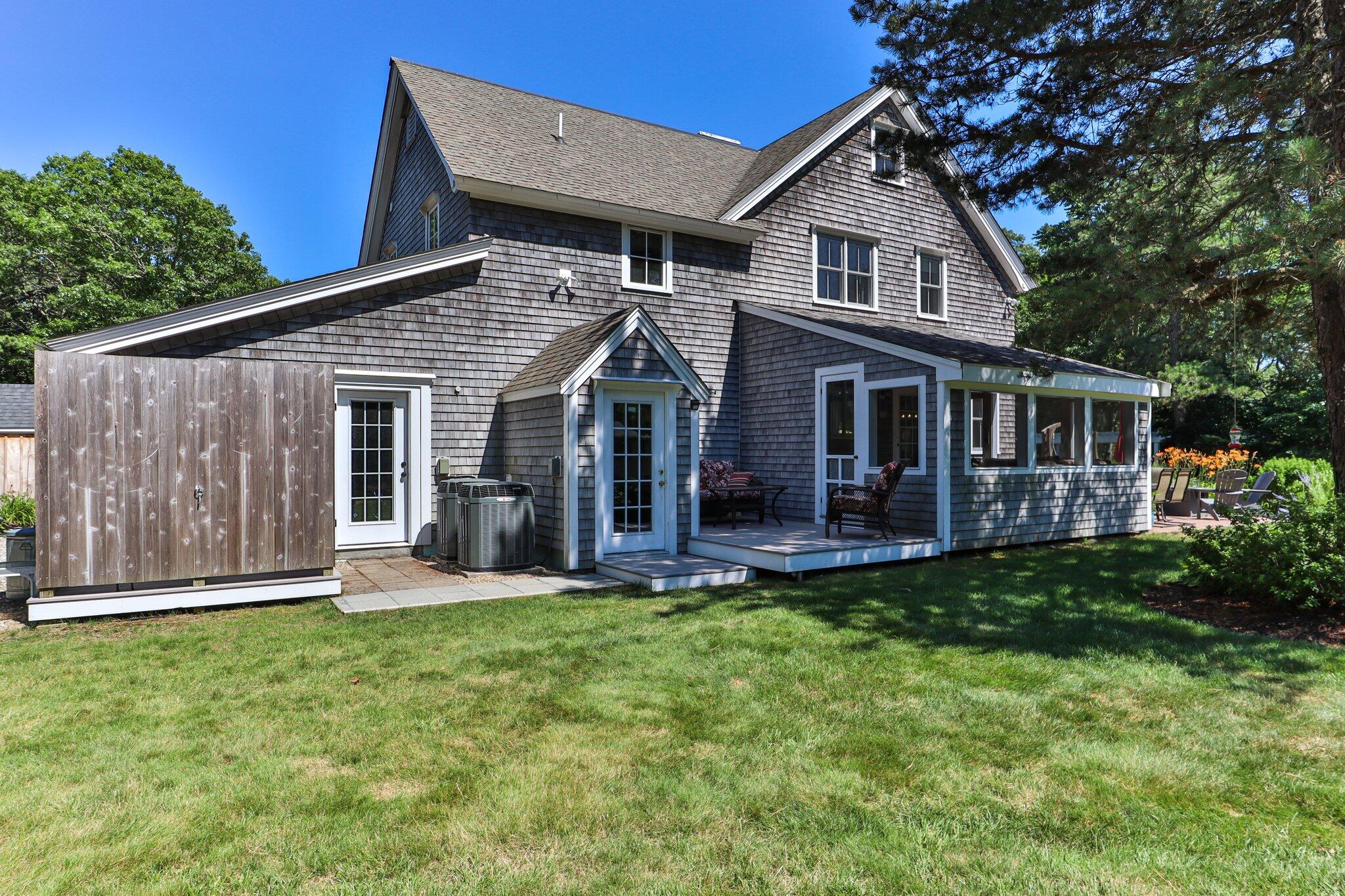 730 Slough Road Brewster, MA 02631 - Photo 65 of 87 a front view of a house with a yard