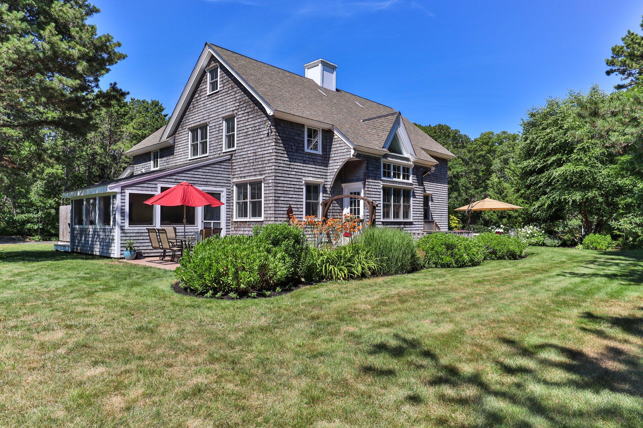 730 Slough Road Brewster, MA 02631 - Photo 74 of 87 a front view of a house with garden