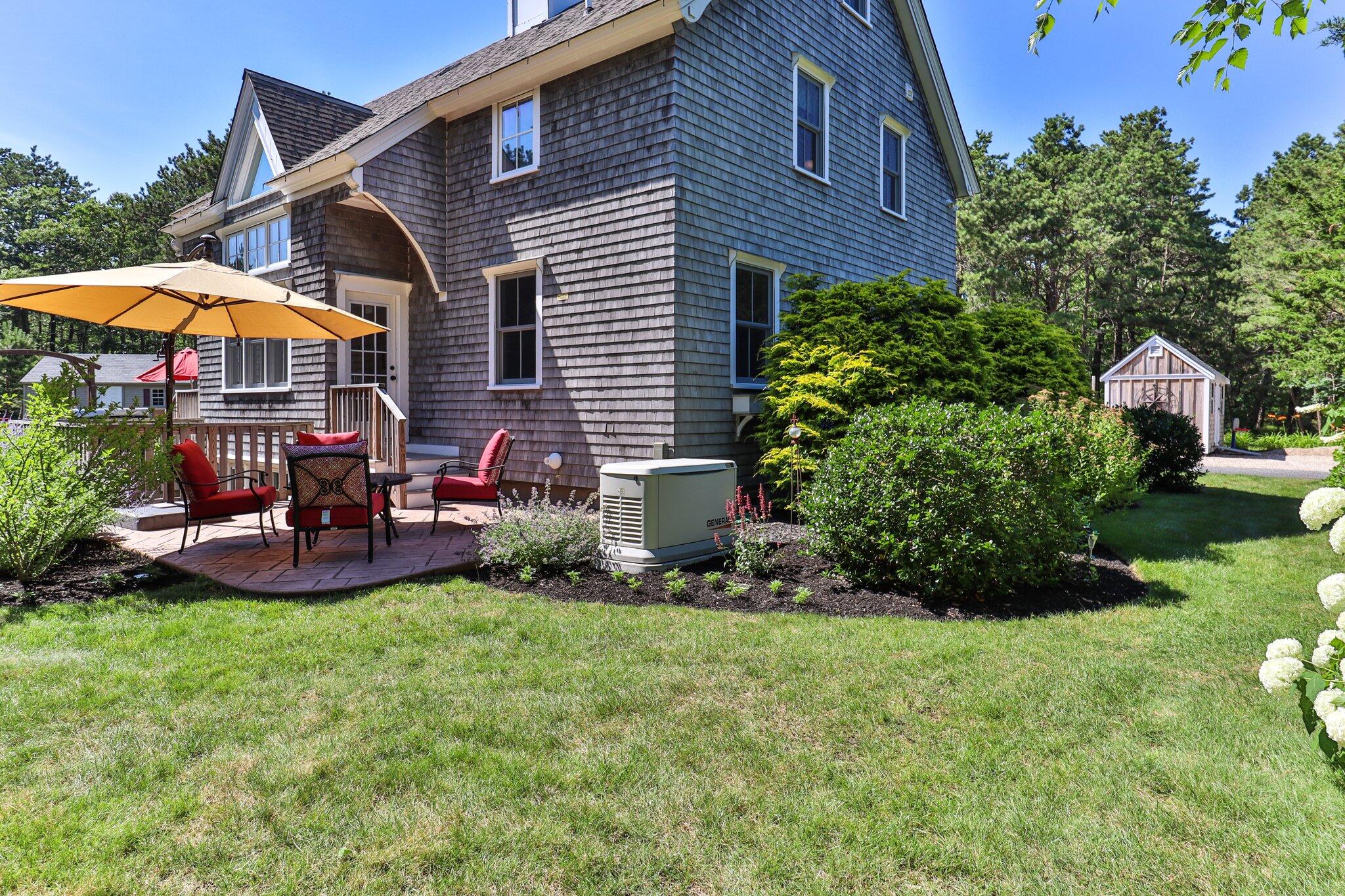 730 Slough Road Brewster, MA 02631 - Photo 80 of 87 a view of a house with a yard and sitting area