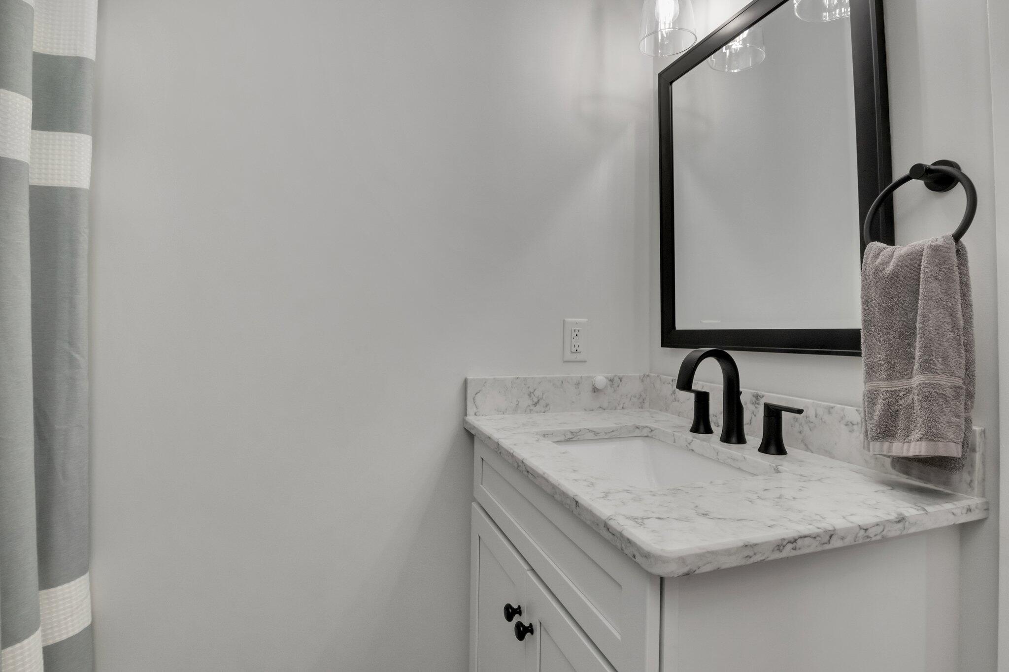 730 Slough Road Brewster, MA 02631 - Photo 10 of 87 a bathroom with a sink and a mirror