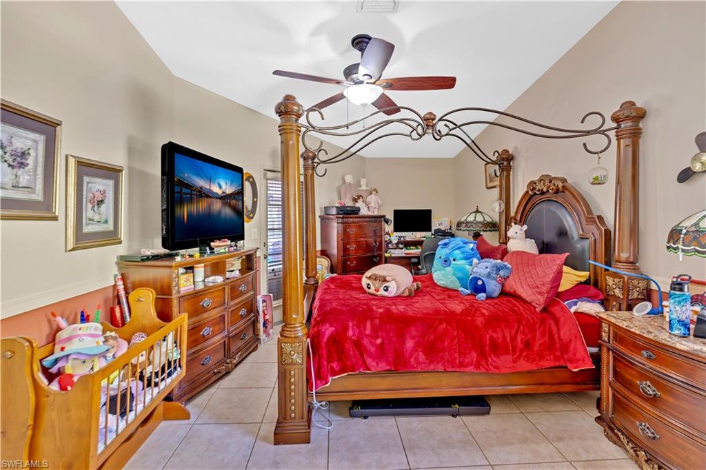 1867 17th Street Southwest Naples, FL 34117 - Photo 16 of 31 Bedroom with light tile patterned floors and a ceiling fan
