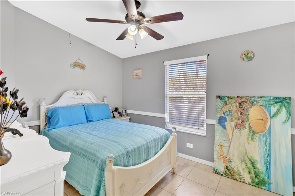 1867 17th Street Southwest Naples, FL 34117 - Photo 17 of 31 Bedroom with a ceiling fan and light tile patterned floors