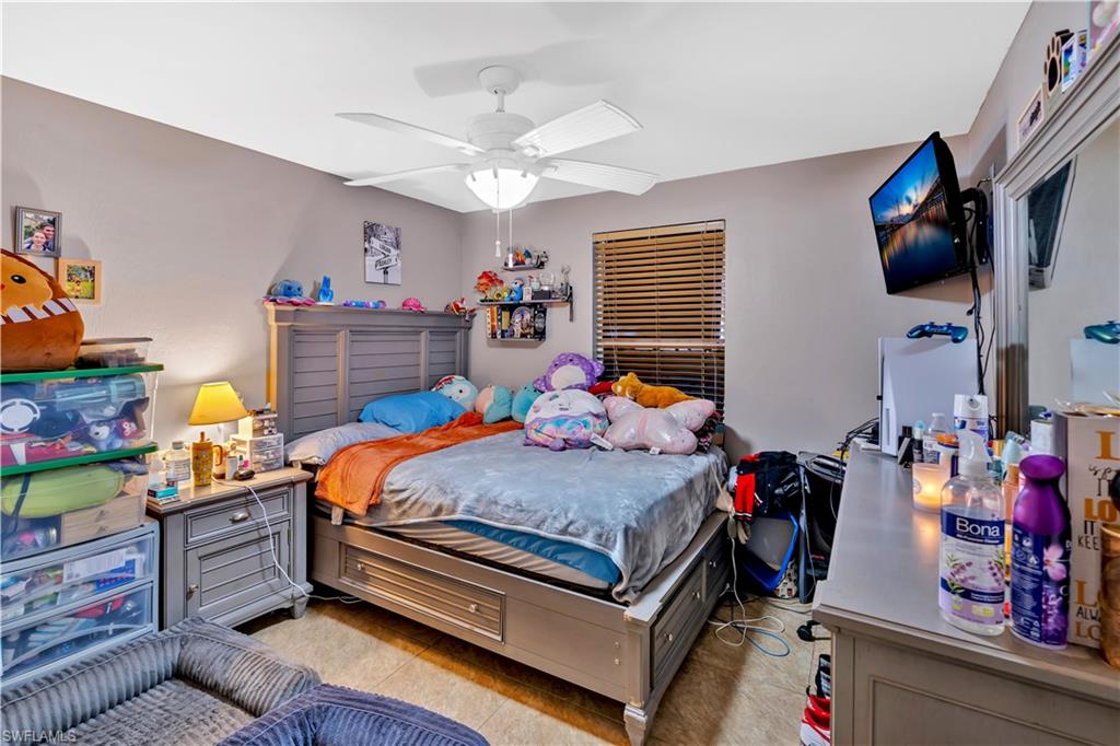 1867 17th Street Southwest Naples, FL 34117 - Photo 19 of 31 Bedroom featuring ceiling fan and light tile patterned floors