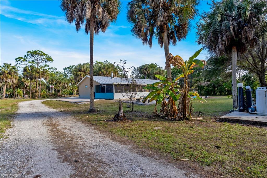 1867 17th Street Southwest Naples, FL 34117 - Photo 25 of 31 View of front of property with driveway and a front yard