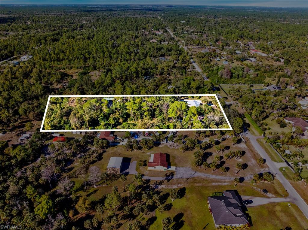 1867 17th Street Southwest Naples, FL 34117 - Photo 29 of 31 Aerial overview of property's location featuring a forest and property boundaries highlighted