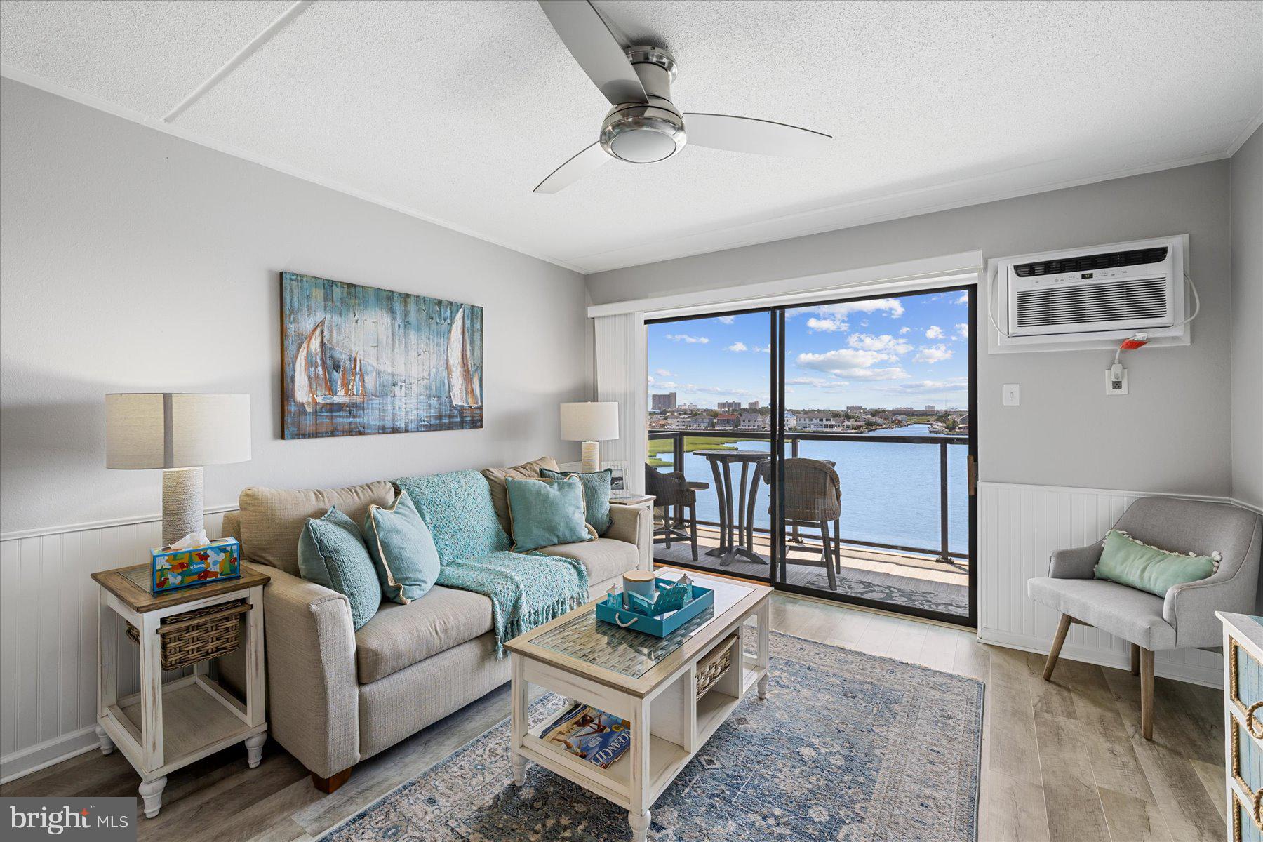 a living room with furniture and a floor to ceiling window