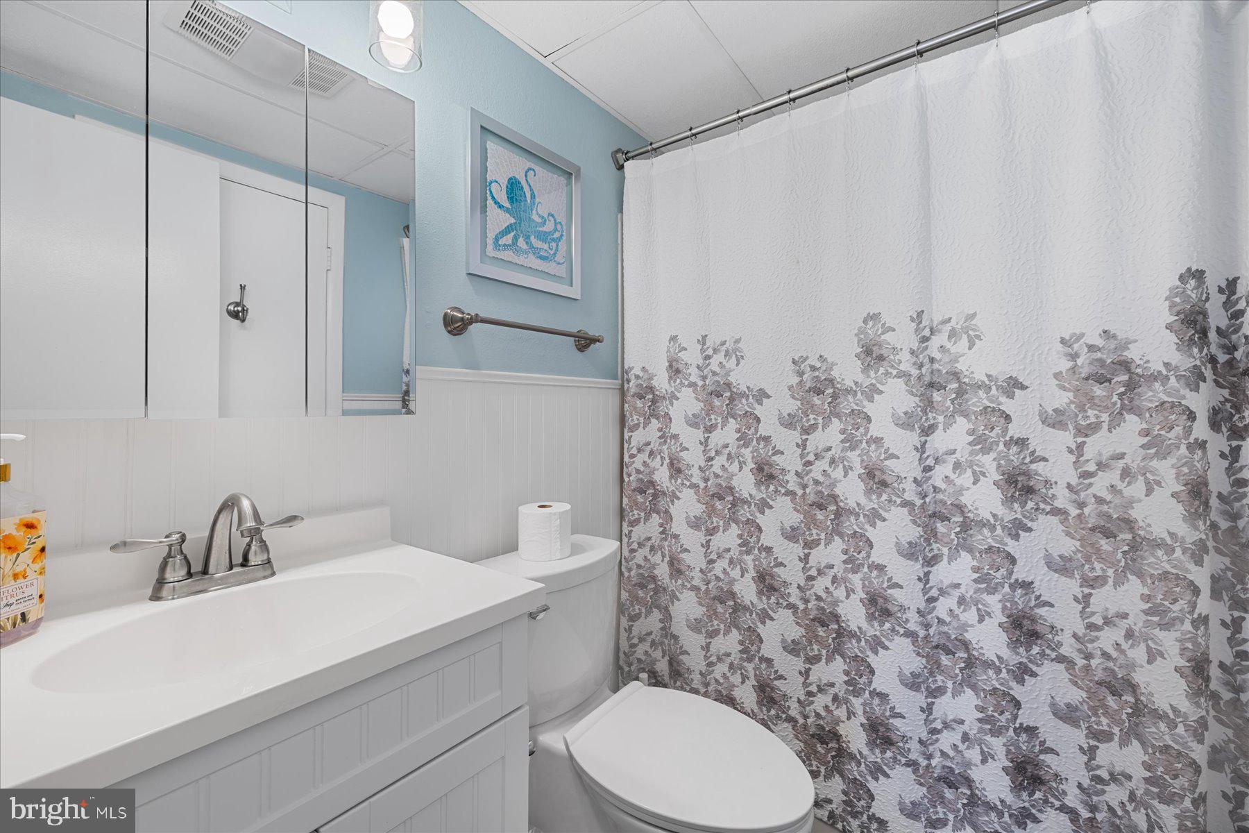 169 Jamestown Road, Unit 503 Ocean City, MD 21842 - Photo 11 of 18 a bathroom with a toilet sink and mirror