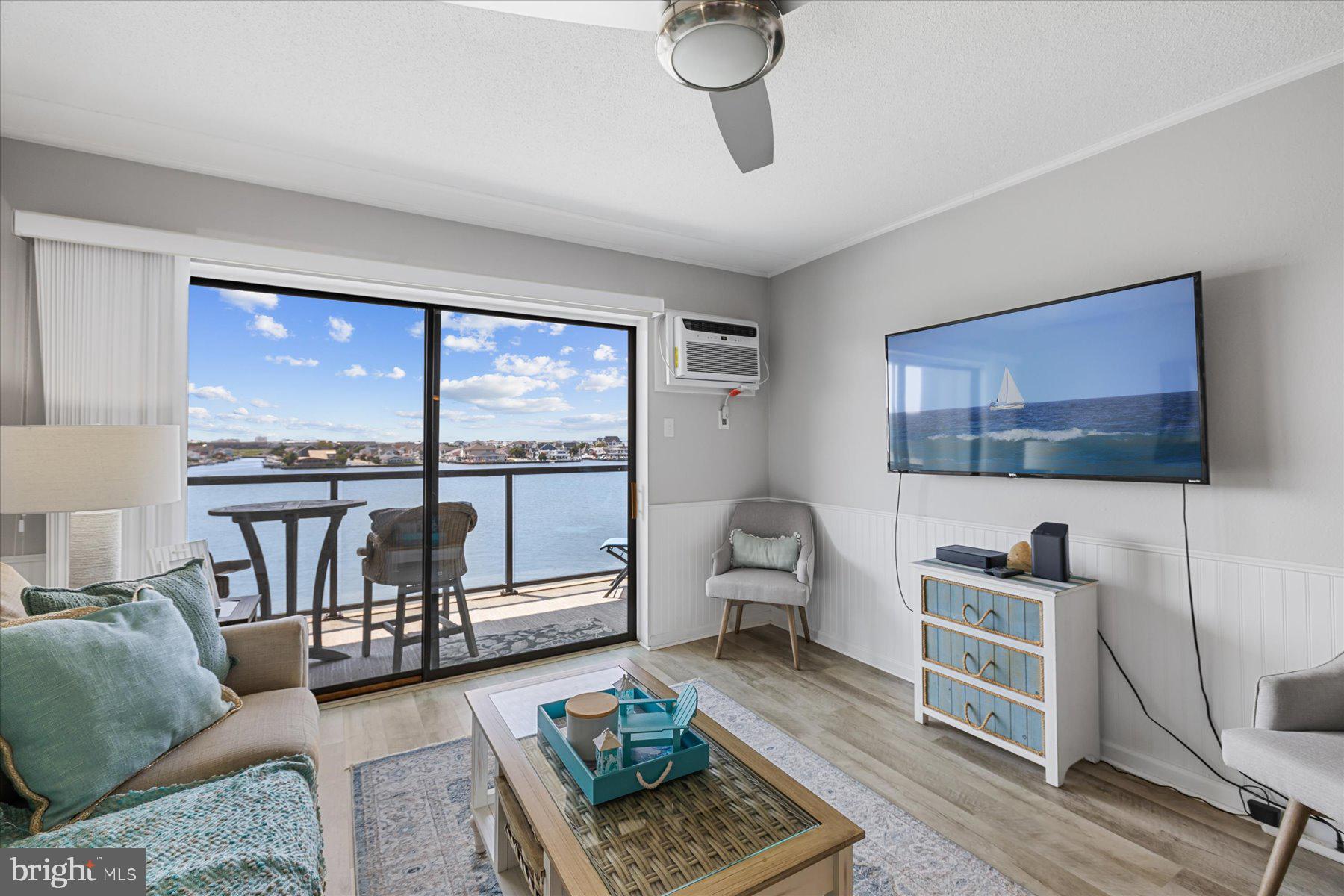 169 Jamestown Road, Unit 503 Ocean City, MD 21842 - Photo 2 of 18 a living room with furniture and a flat screen tv