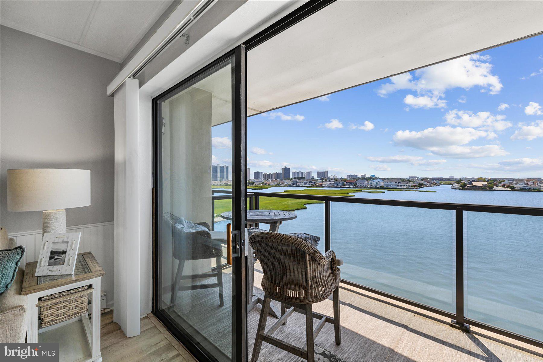 169 Jamestown Road, Unit 503 Ocean City, MD 21842 - Photo 3 of 18 a view of a swimming pool and chairs in the balcony