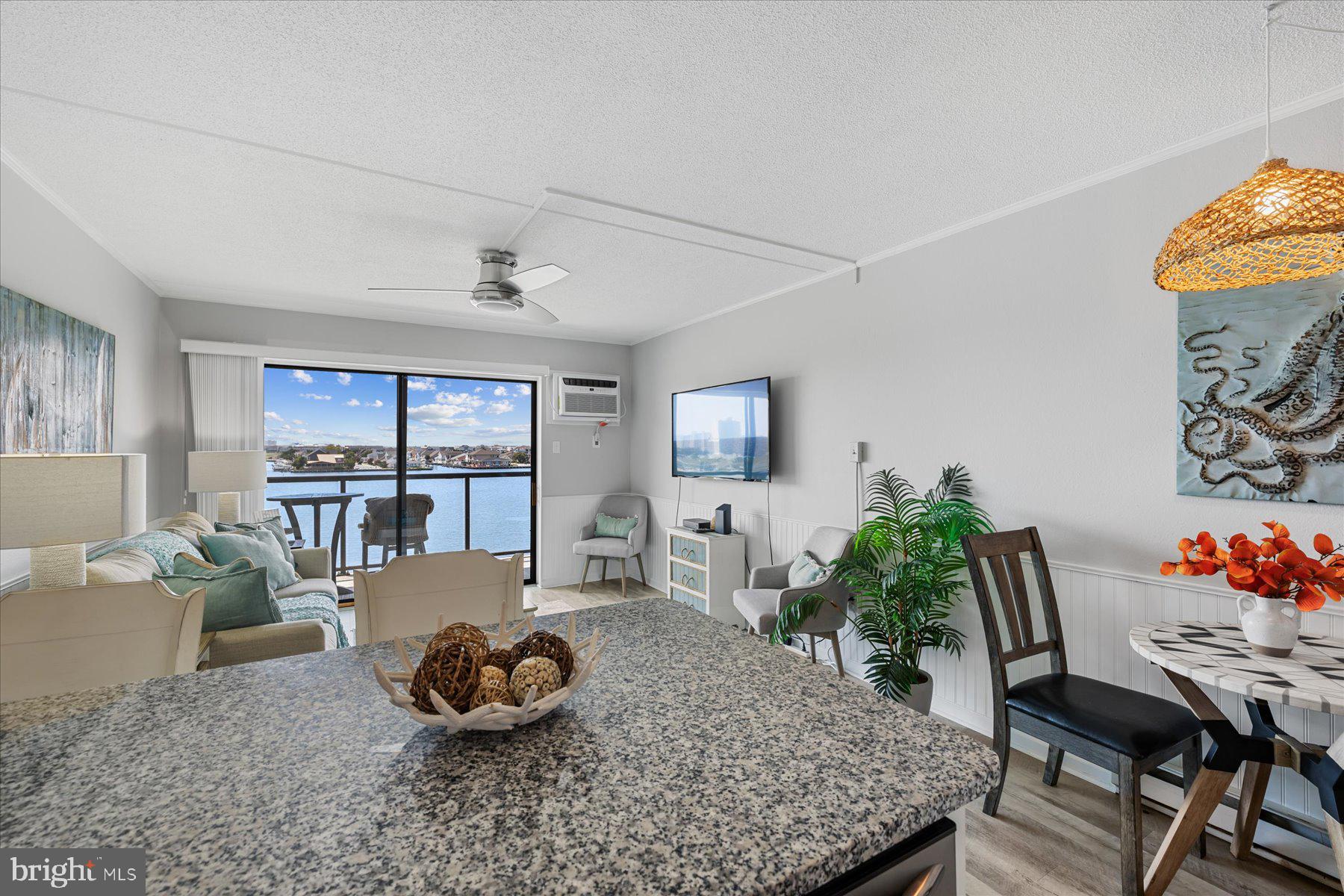 169 Jamestown Road, Unit 503 Ocean City, MD 21842 - Photo 4 of 18 a living room with furniture and a potted plant