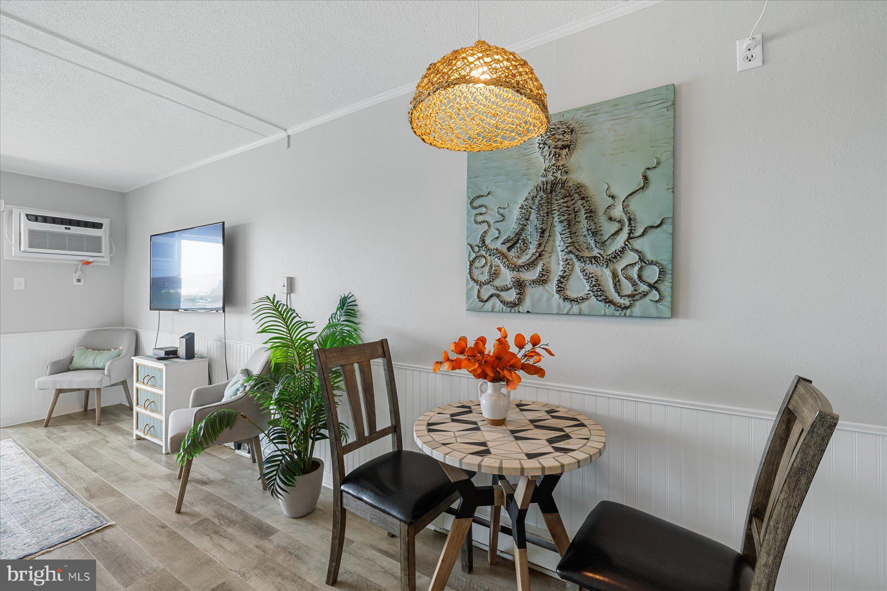 169 Jamestown Road, Unit 503 Ocean City, MD 21842 - Photo 7 of 18 a view of a dining room with furniture and wooden floor
