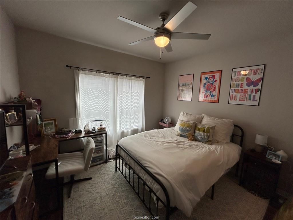 3102 Green Street Bryan, TX 77801 - Photo 13 of 26 a bedroom with a bed and a chandelier