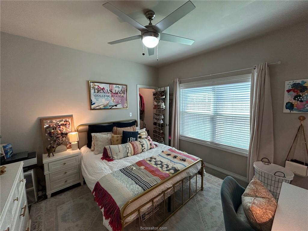 3102 Green Street Bryan, TX 77801 - Photo 8 of 26 a bedroom with a bed and a chandelier