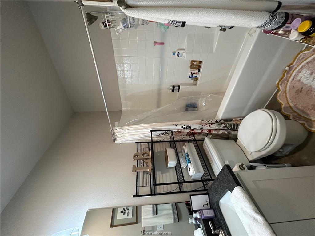 3102 Green Street Bryan, TX 77801 - Photo 9 of 26 a bathroom with a sink toilet and shower