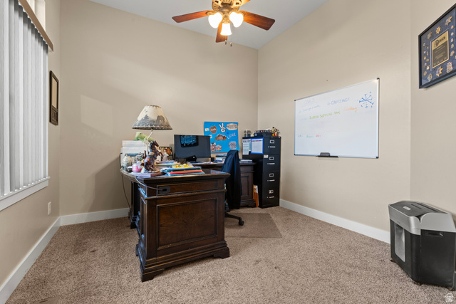 4557 North Ranch Road East Tooele, UT 84074 - Photo 5 of 43 Neutral tone wall paint, vaulted ceiling, ceiling fan with light fixture, vertical window blinds, and carpet flooring