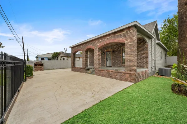 a view of a kitchen with wooden floor and electronic appliances