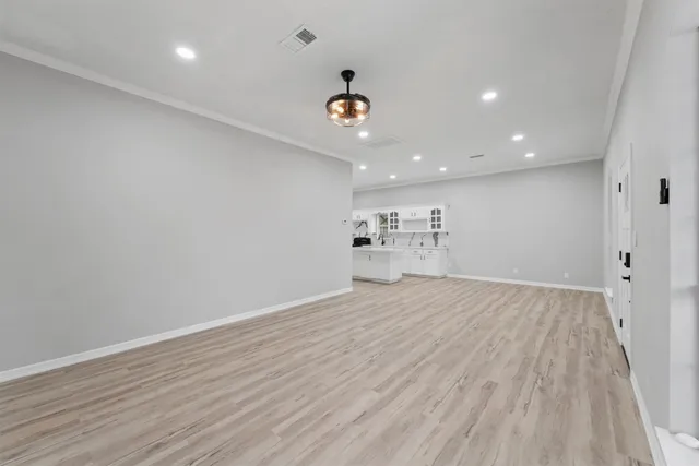 a view of a big room with wooden floor and a ceiling fan