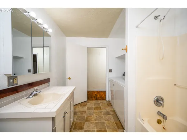 a bathroom with a sink a toilet a shower and a mirror