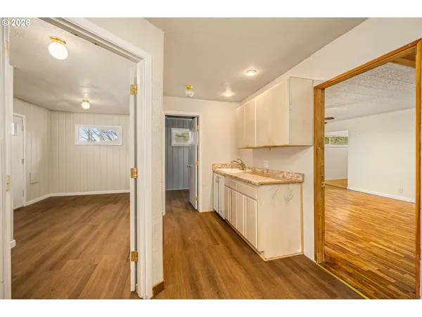 a open kitchen with granite countertop a refrigerator and a sink