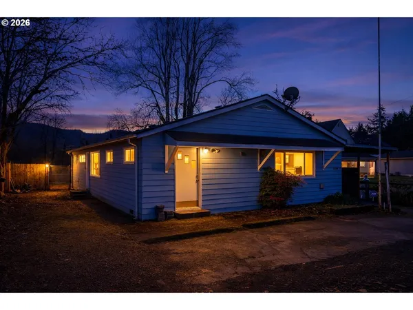 a view of a house with a wooden deck
