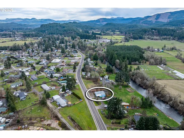 an aerial view of residential house with outdoor space and mountain view