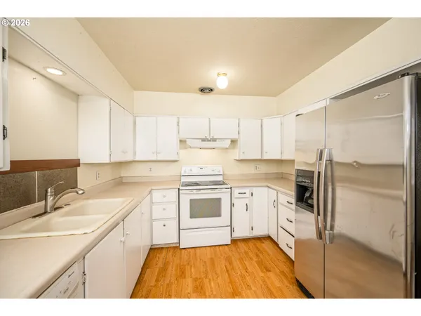 a kitchen with a sink stove and refrigerator