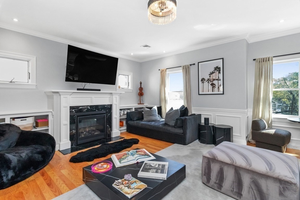 20 College Farm Road Waltham, MA 02451 - Photo 8 of 32 a living room with furniture a flat screen tv and a fireplace