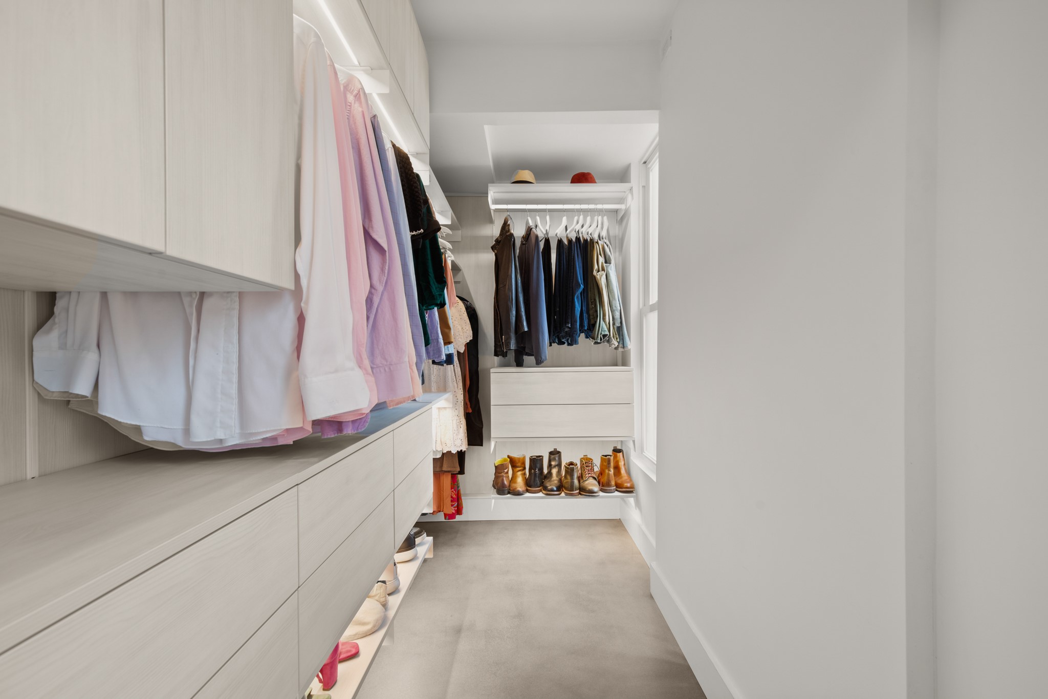 1813 Crooked Lane Austin, TX 78741 - Photo 19 of 39 a view of walk in closet with clothes and shoes