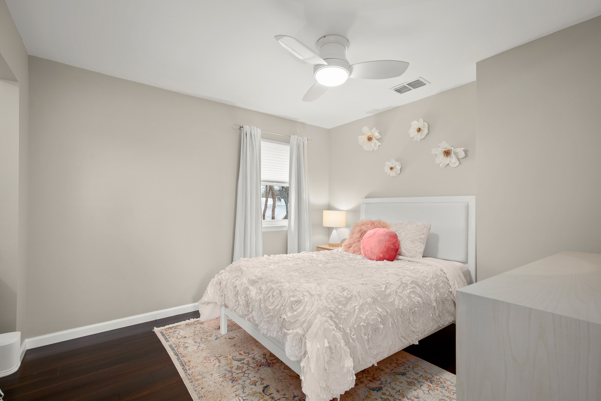 1813 Crooked Lane Austin, TX 78741 - Photo 23 of 39 a bedroom with a bed and a chandelier