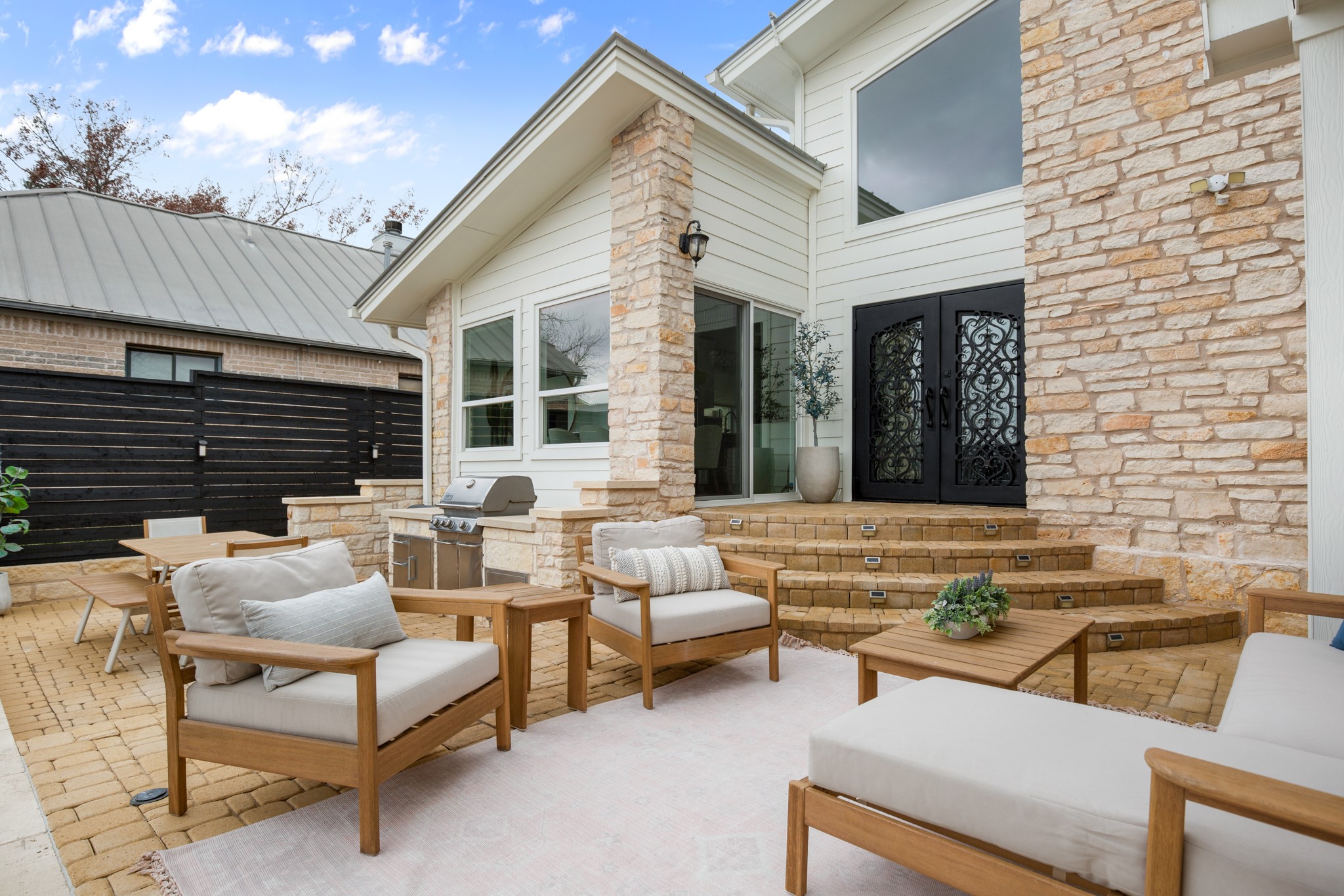 1813 Crooked Lane Austin, TX 78741 - Photo 38 of 39 a view of a patio with couches table and chairs with wooden floor and fence
